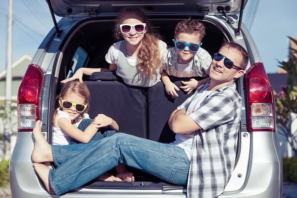 Happy family getting ready for road trip on a sunny day