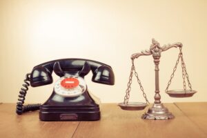 Law scales and retro telephone on table