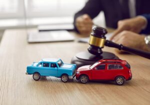 Little crashed autos on table in courtroom