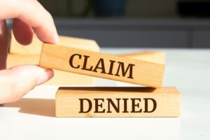 Claim Denied written on wooden blocks.